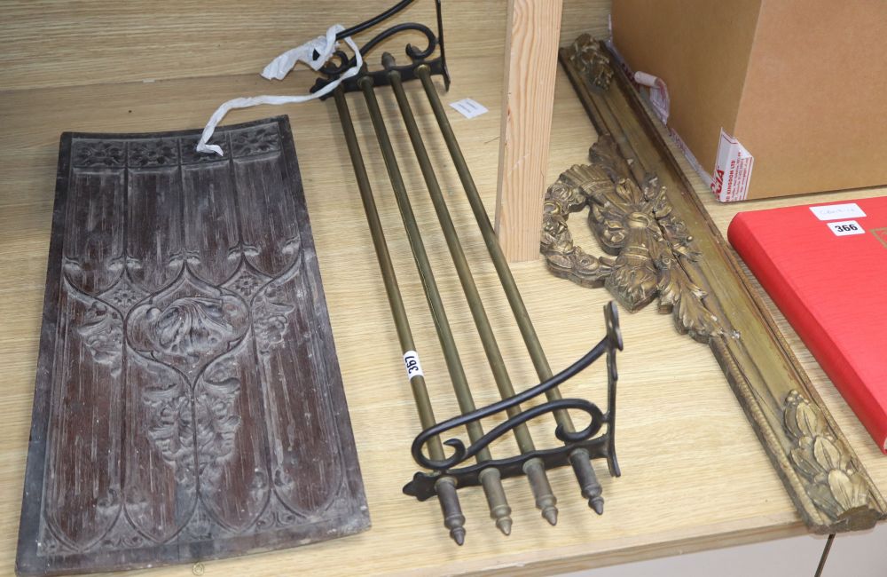 An Italian carved walnut panel, a giltwood frieze and a brass wall rack